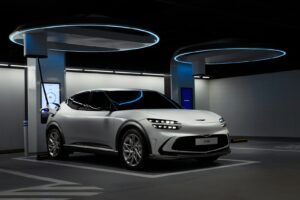 a white sports car in a showroom ricarica veloce auto elettriche Milano