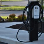 black metal stand on gray concrete road during daytime auto elettriche 2025